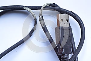 Damaged black usb cable plug and micro usb plug or Old Smart Phone Charger Cable broken on white acrylic background, Close up