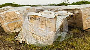 Damaged or broken photovoltaic solar panel / module pallets, stacked outside