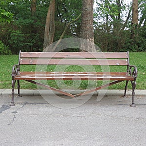Damaged and broken wooden bench in the city park, vandalism concept.