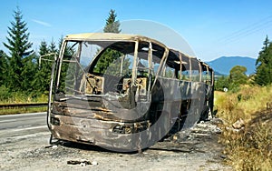 Damaged and burned bus on the road. Car wreck