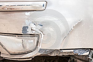 Damaged car front bumper with crack and scratched peeling paint