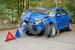 Damaged car with warning triangle