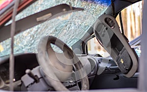 Damaged car window after an accident. Broken windshield as a result of an accident, inside view. Cabin interior details, view from