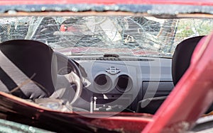 Damaged car window after an accident. Broken windshield as a result of an accident, inside view. Cabin interior details, view from