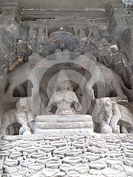 Damaged carving of Lakshmi, Goddess of Wealth & principle aspect of the Mother goddess, sitting on a lotus throne, Kailasa, Ellora