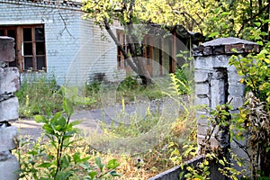 Damaged concrete fence of old abandoned sanatorium