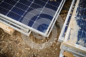 Damaged and cracked solar panels with fractured glass.