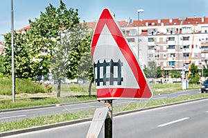 Damaged and distorted railway sign with railroad crossing road symbol signalization in the city