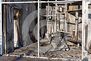 Damaged facade of a retail store after a fire.