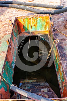 Damaged gangway with ladder leading to lower deck of a crashed cargo ship, flooded with water