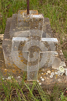 Damaged grave headstone with cross