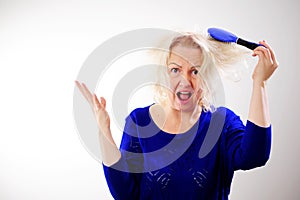 Damaged Hair. Sad adult Woman With Disheveled Comb Closeup Portrait Of Female Model Holding Unbrushed Dry Hair In Hands