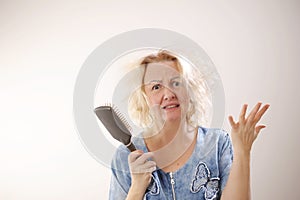 Damaged Hair. Sad adult Woman With Disheveled Comb Closeup Portrait Of Female Model Holding Unbrushed Dry Hair In Hands