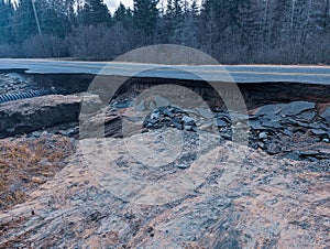 Damaged highway from a broken beaver dam, Road washout photo