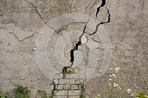 Damaged house dilapidated old building wall. Private abandoned home fall to ruin. Sunny day, horizontal orientation, nobody