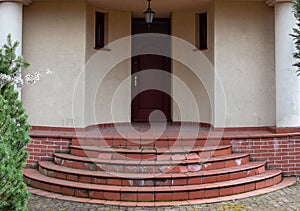 Damaged house staircase or stairs with broken tiles over concrete steps