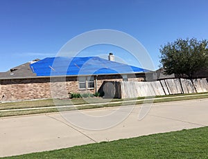 Damaged house by tornado in community