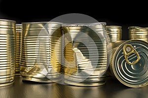 Damaged metal can with vegetables on a wooden table. Canned vegetables in a can