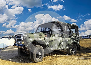 A damaged military armored vehicle, a passenger car , a jeep and equipment on the battlefield. military technics.