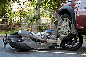 Damaged motobike and a car in a accident