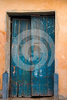 Damaged old blue wooden door, Havana, Cuba