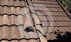 Damaged old roof tile in need of repair
