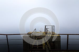 Damaged pier in the mist at morning