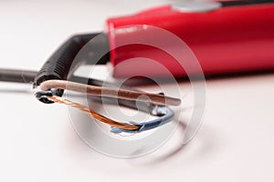 Damaged power cord for household appliances. Broken cord from heavy use. The appliance needs to be repaired. Soft focus