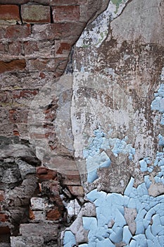 Damaged red brick wall texture background. Old weathered and cracked red and orange bricks