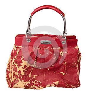 Damaged red clutch with faux leather peeled and cracked isolated on white