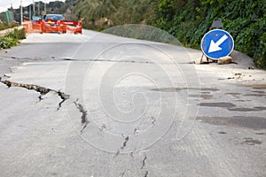 Damaged road with big cracks