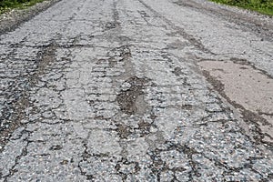 Damaged road with cracked asphalt