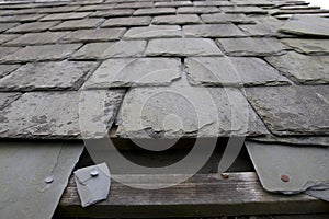 Damaged roof with missing slates