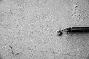 Stripped and damaged Philips screw on a wood surface photo