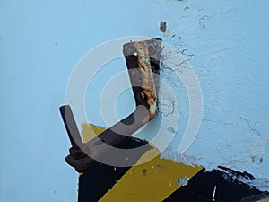 Damaged  steel anchor hook on wall