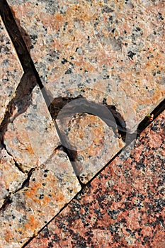 Damaged stone slabs with cracks close-up.