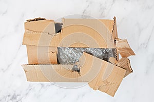 Damaged and torn cardboard box for transporting things. Top view.