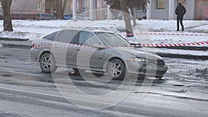 Damaged vehicle, barrier tape, accident on street