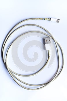 Damaged white usb cable plug and micro usb plug or Old Smart Phone Charger Cable broken on white acrylic background, Close up