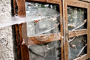 Damaged window of abandoned retro building