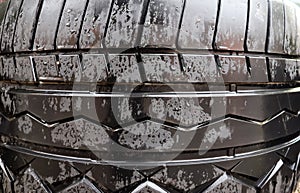 Damaged and worn old black tires on a stack. Damaged and worn old black tires on a stack. Tire tread problems. Solutions concept.