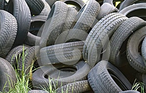 Damaged and worn old black tires on a stack. Damaged and worn old black tires on a stack. Tire tread problems. Solutions concept.