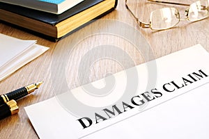 Damages claim form and pen. Insurance.