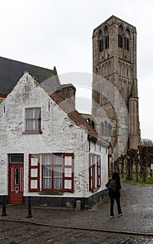 Damme, Flemish Region - Belgium - Tower of a medieval rectangular church and a vintage farmer house