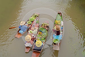 Damnoen Saduak Floating Market or Amphawa. Local people sell fruits, traditional food on boats in canal, Ratchaburi District, photo