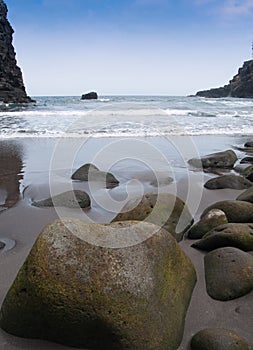 Damp stones on the sand beach