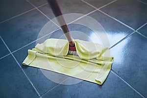 Damp wiping tiled floor with floor cleaning cloth