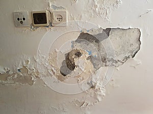 Dampness on peeling wall. Domestic disaster. photo