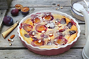 Damson blue plum clafoutis flan, icing sugar and almonds dressing