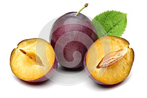Damson plums with leaves on white background